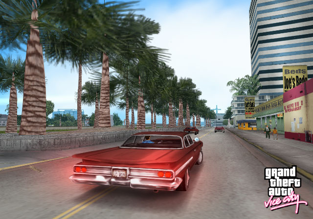 Official original Vice City screenshot of a red car on a palm-lined beachfront road
