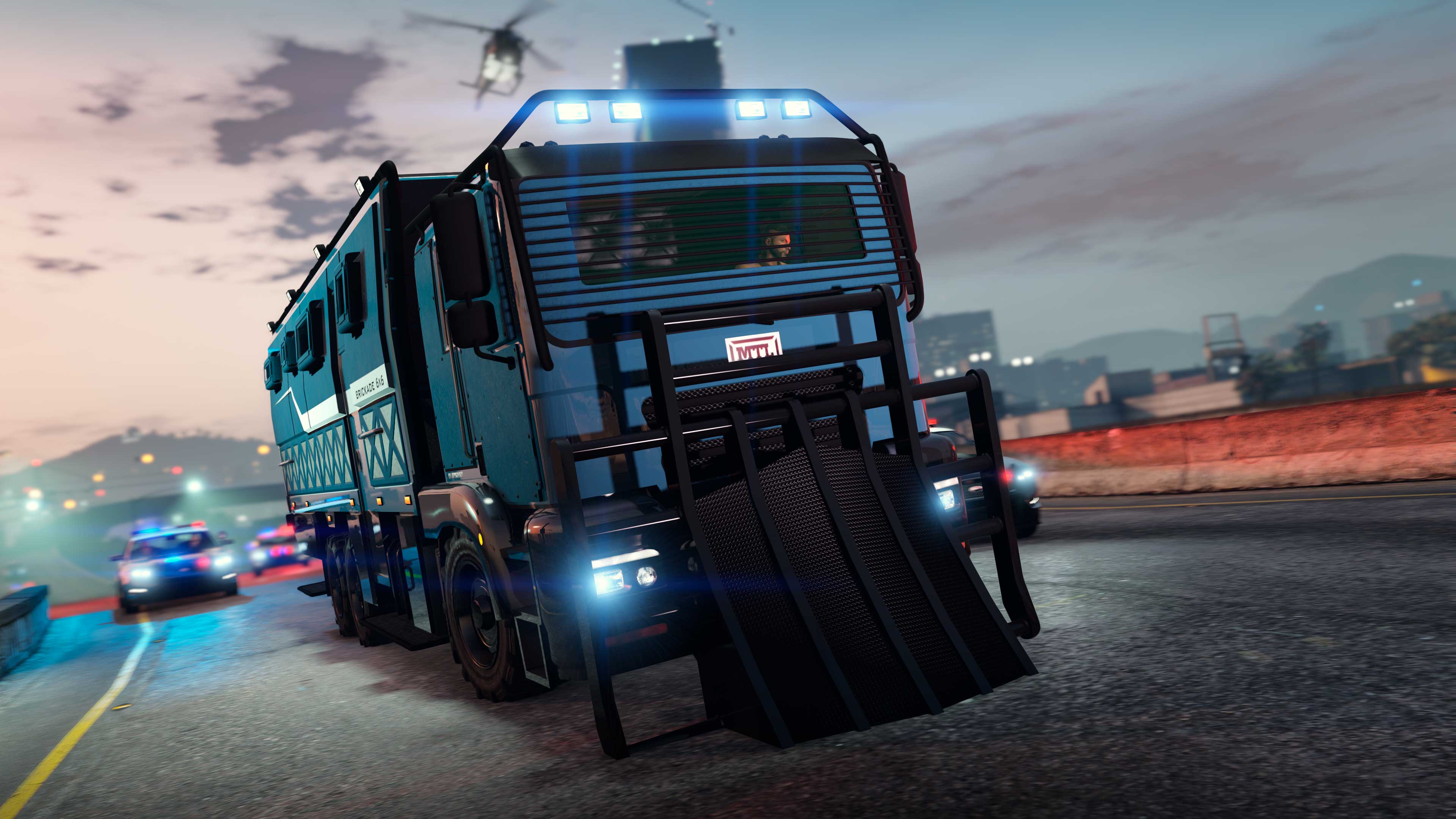 A MTL Brickade 6x6 truck with a ramped scoop on the bonnet evades pursing cops. 