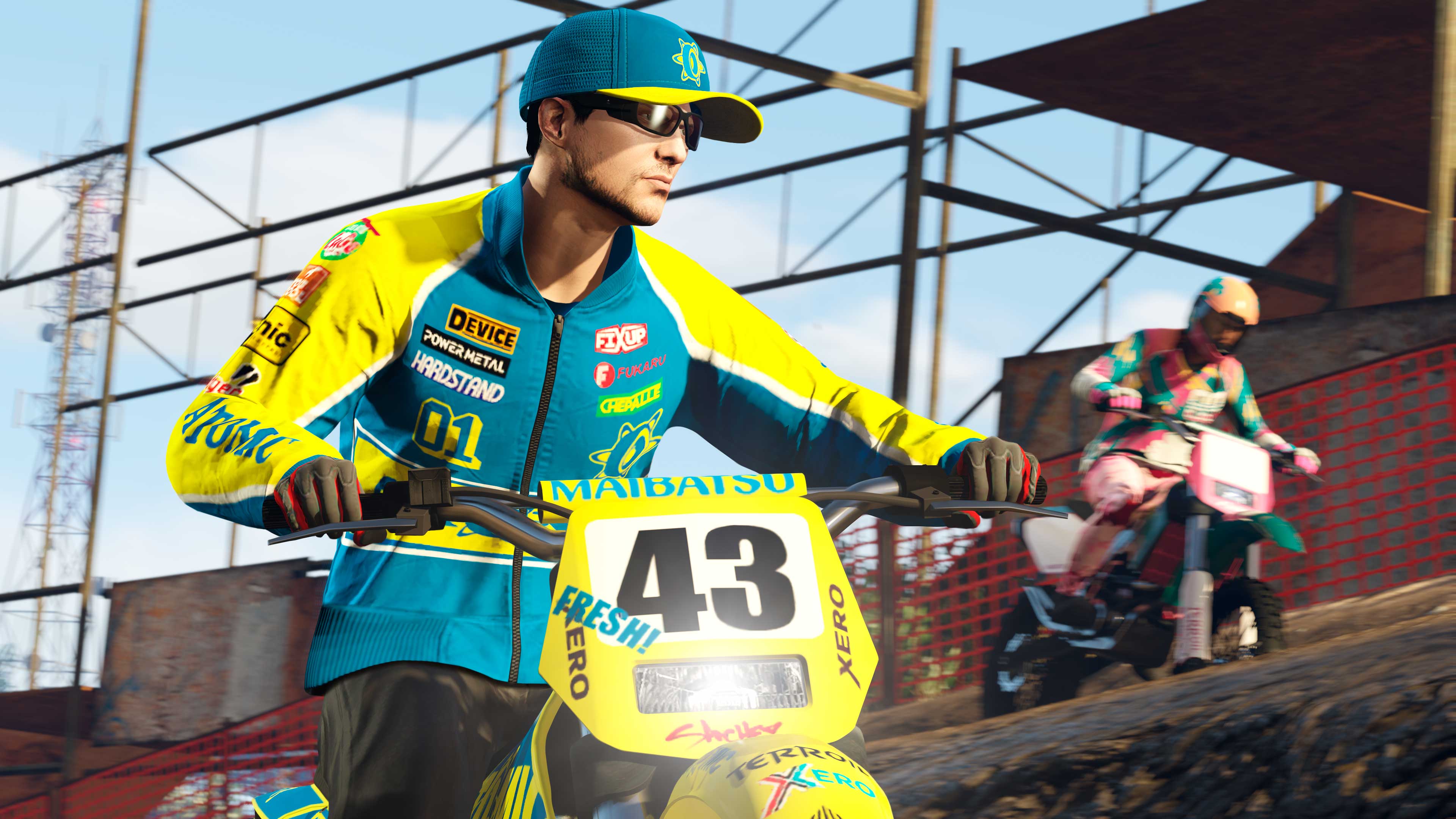 A character wearing the Atomic Racing Bomber Zipped and Atomic Racing Cap while riding a dirt bike. 