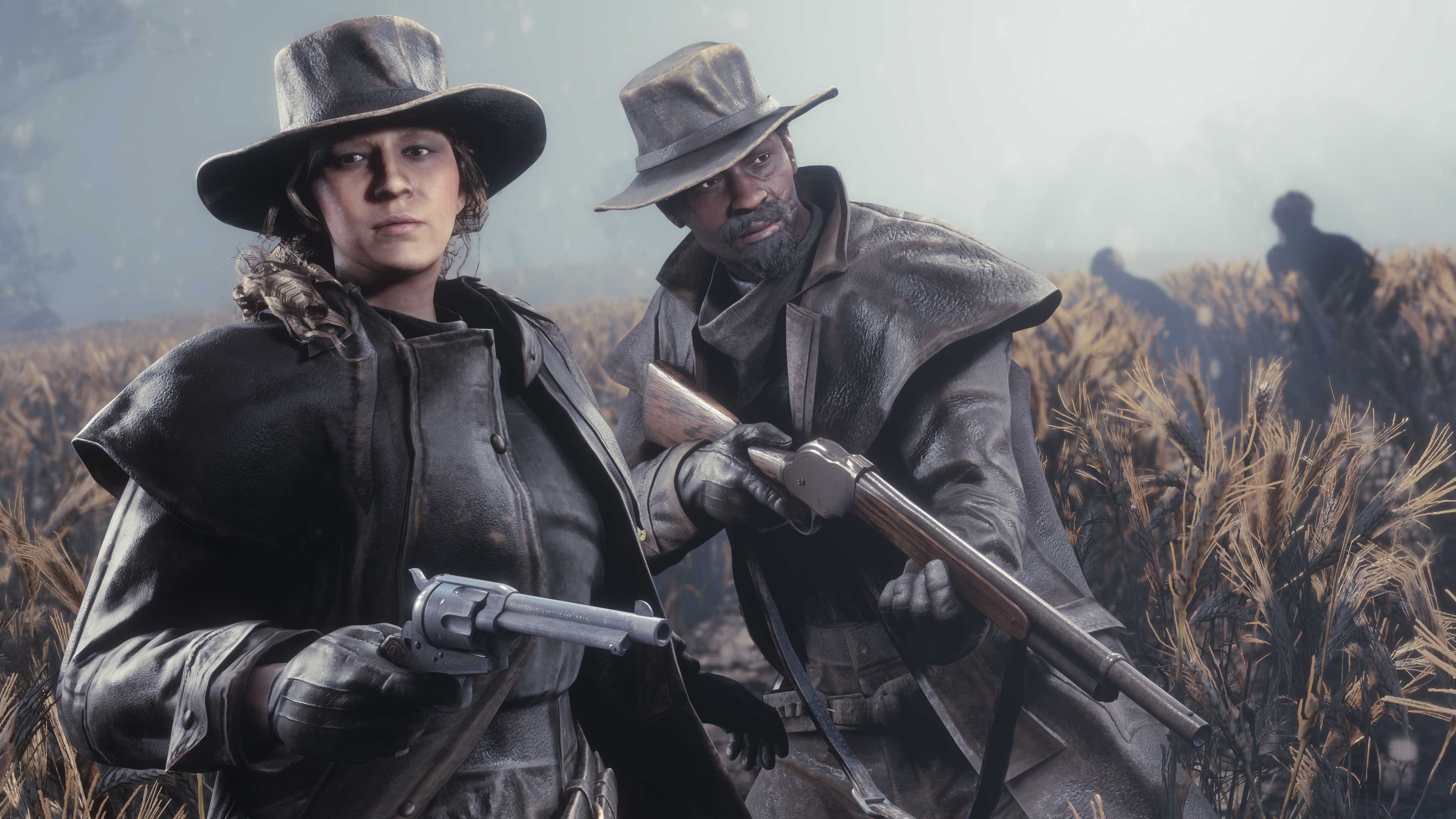 Two Red Dead Online characters wearing the Community-Inspired Outfit hold their weapons amongst tall grass with shadowed figures behind them.
