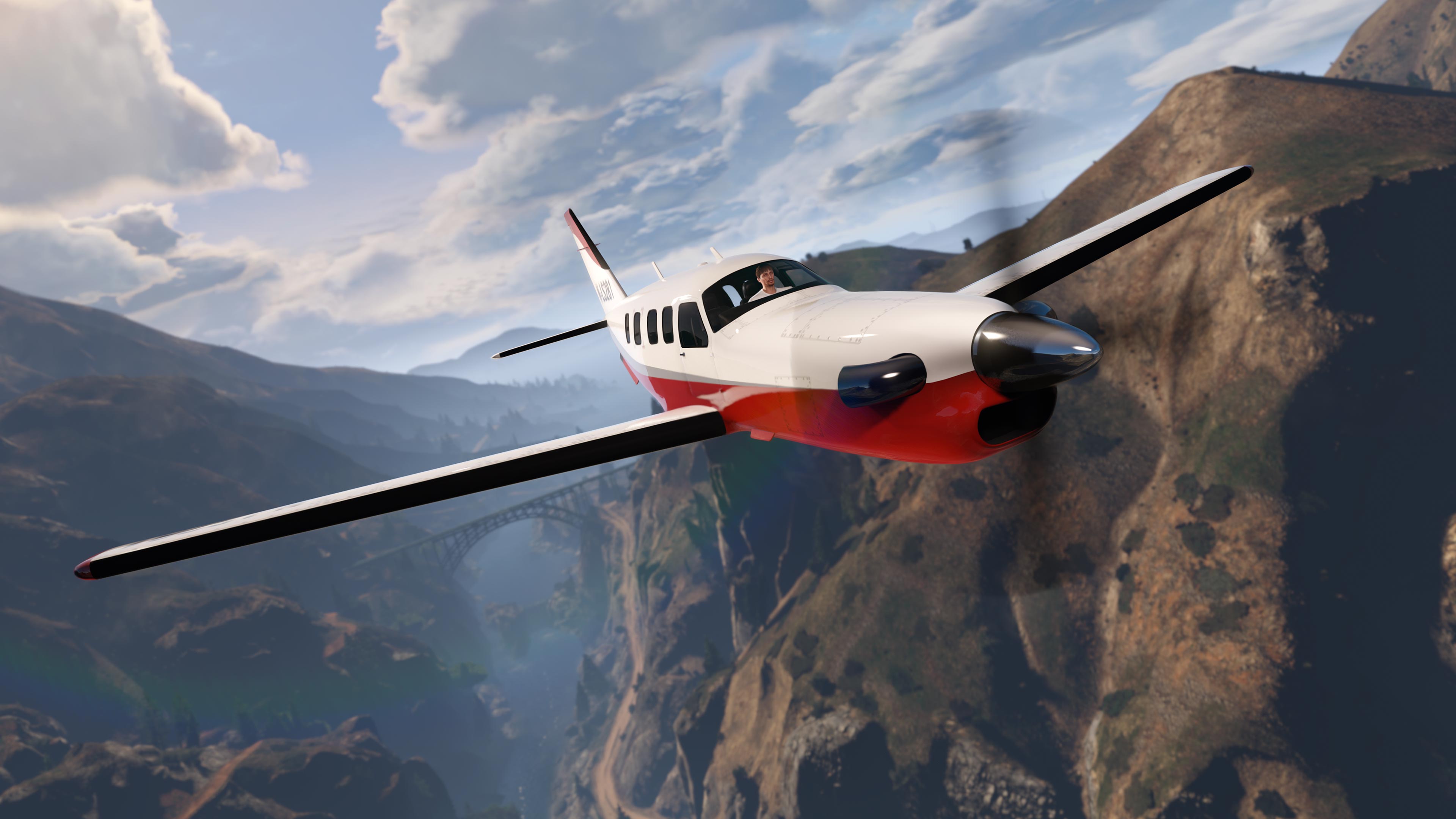 Un avión JoBuilt Velum de 5 asientos vuela entre montañas.