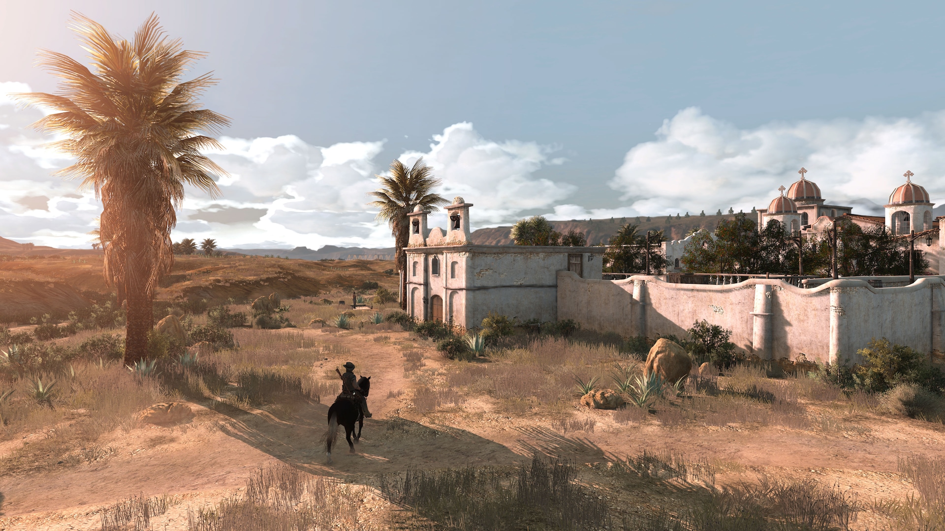 John Marston rides his horse as they walk towards the sun-kissed Las Hermanas settlement.